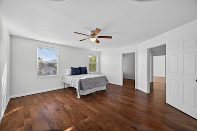Bedroom featuring dark wood-style floors and a ceiling fan