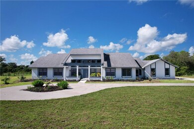 View of front of home featuring a front yard, curv