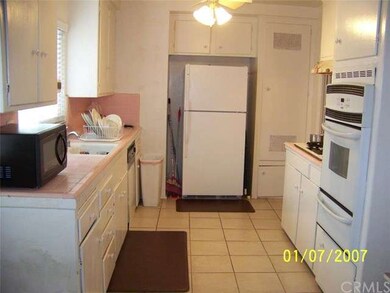 Another view of kitchen with newer wall oven and d