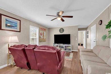 Living room with hardwood / wood-style flooring, a