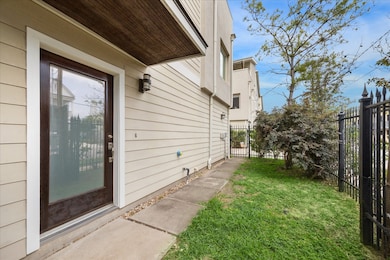 Beautiful entrance leading to a small fenced yard