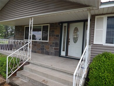 Stone accents and welcoming wide steps and front d