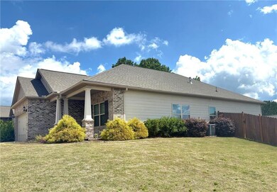 View of side of home with brick siding, a garage, 