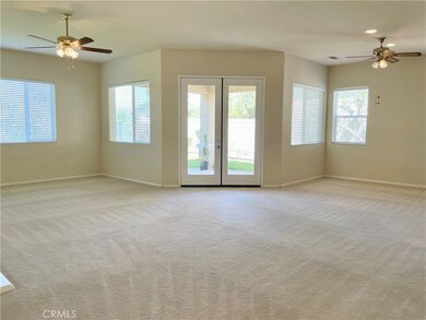 The living area is bright and open, with beautiful views from the windows and patio doors.