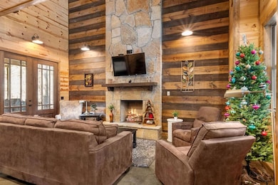 Living room with a towering ceiling, wood walls, f