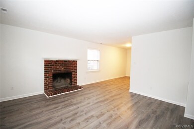 Unfurnished living room featuring a fireplace and wood-type flooring