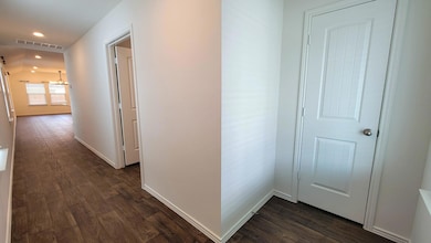 Hall with dark wood-type flooring and recessed li