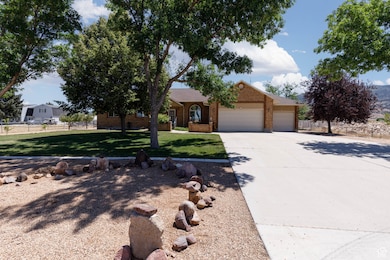 View of front of property featuring a garage, concrete driveway, and brick siding