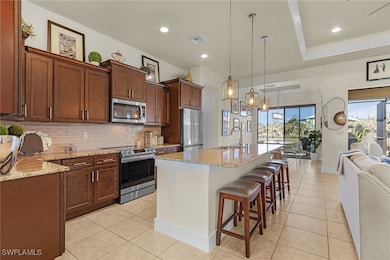 Kitchen featuring visible vents, backsplash, appli