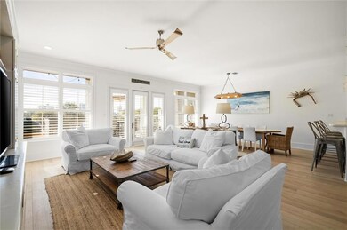 Living room with ceiling fan and light hardwood / wood-style floors