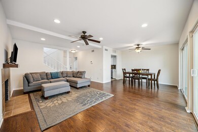 Living room featuring a ceiling fan, a fireplace,