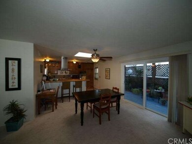 Skylight, inviting deck adjoin dining area and kit