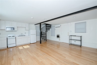 Unfurnished living room with light wood-style floo