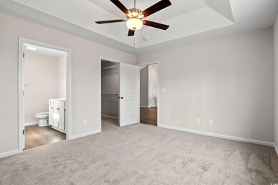 Unfurnished bedroom with carpet, a spacious closet