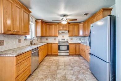 Kitchen boasts lots of cabinets and counter space