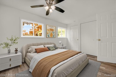 Bedroom featuring wood finished floors, a ceiling fan, and a closet