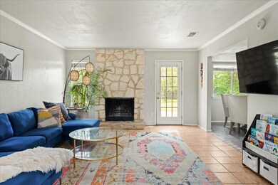 Tiled living room with a stone fireplace, a textu