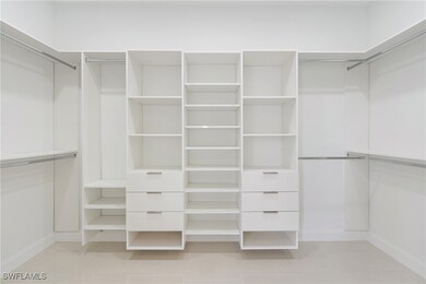 Walk in closet featuring light tile patterned floo