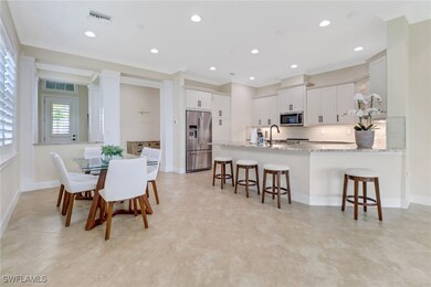 Dining area featuring ornamental molding, light ti
