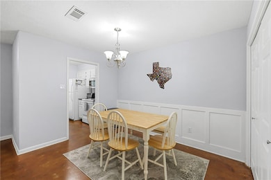 Dining space with a chandelier, finished concrete