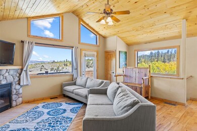 Living room featuring ceiling fan, a fireplace, pl
