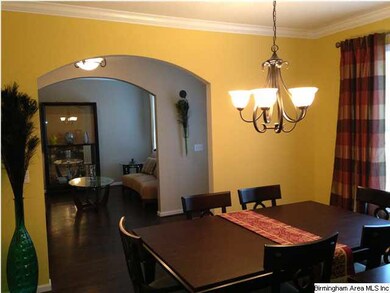 Dining room has arched entry from foyer and kitche