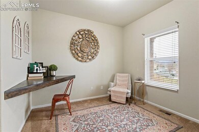 Carpeted office space with baseboards and visible 