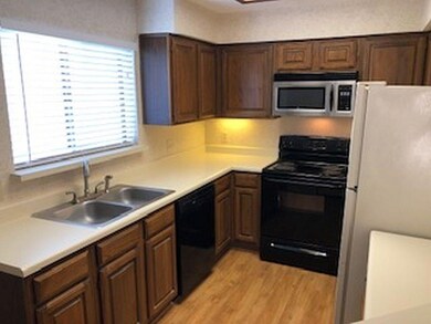 Kitchen is clean with black appliances.