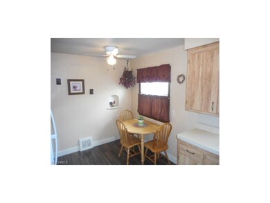 The kitchen offers a lighted ceiling fan, refriger