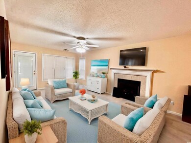 Living room featuring ceiling fan, a fireplace, li