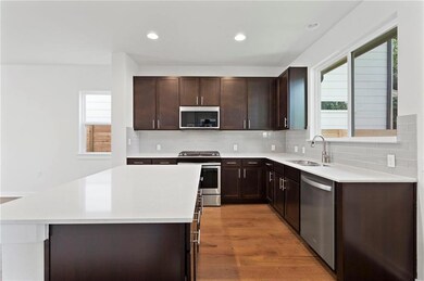 Kitchen with stainless steel appliances, light co