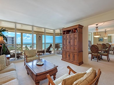 Carpeted living area with floor to ceiling windows, a water view, and crown molding