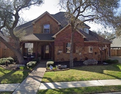 View of front of home with stone siding, roof wit