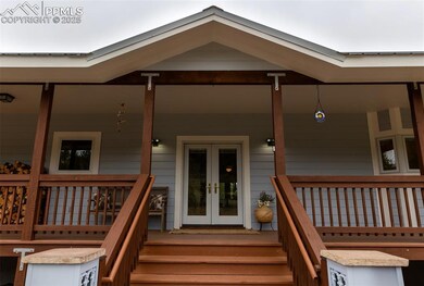 Doorway to property featuring french doors and covered porch