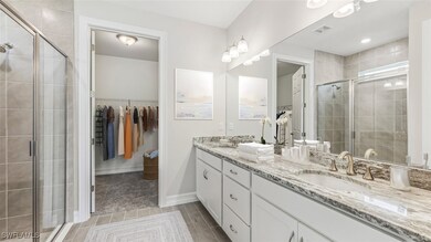 Full bath featuring a spacious closet, double vani