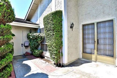Front patio area with double front doors garage en