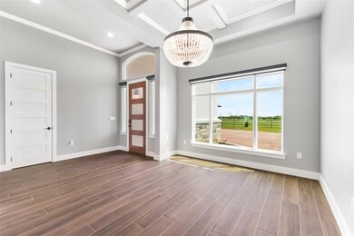 Empty room featuring a chandelier, dark wood-type