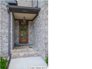 Main entry with custom door and slate flooring