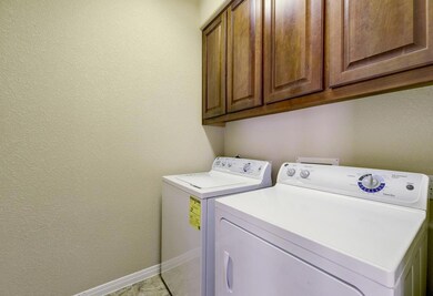 Laundry area featuring cabinet space, washing mac