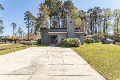 Mid-century modern home featuring a front lawn and
