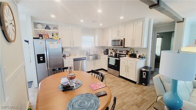 Kitchen with light countertops, visible recessed l