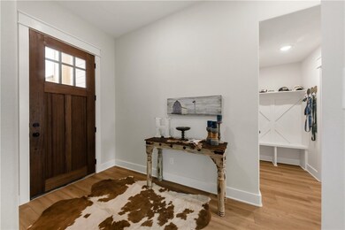 Entryway with wood finished floors and baseboards