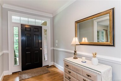 An elegant entry with wooded floors detailed gray 