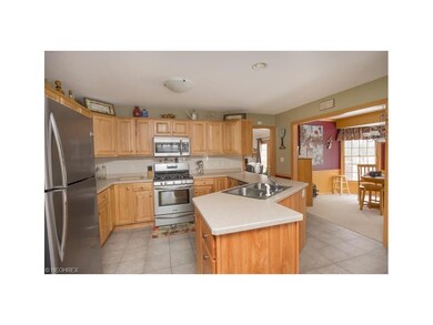 Eat-in kitchen with hickory cabinets, ceramic floo
