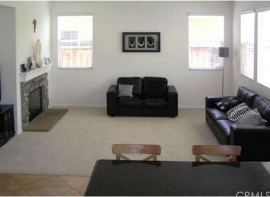 Family room with media hutch next to stone firepla