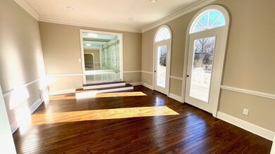 Entryway featuring ornamental molding, baseboards,