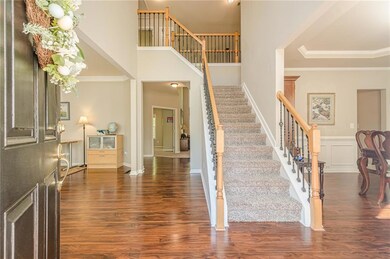 Entryway with a wainscoted wall, wood finished flo