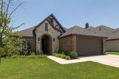 Tudor house with a front lawn and a garage