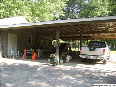 Large carport and storage in back yard