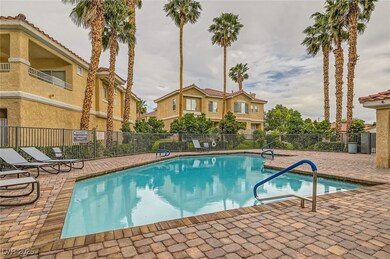 Community pool with fence and a patio area